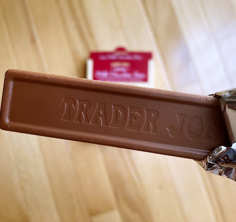Slim chocolate bar half unwrapped.