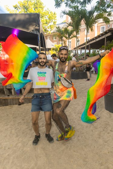 Scenes From NYC Pride Weekend 2022: A Celebration of Solidarity 20 Two people wearing rainbows at a Pride celebration