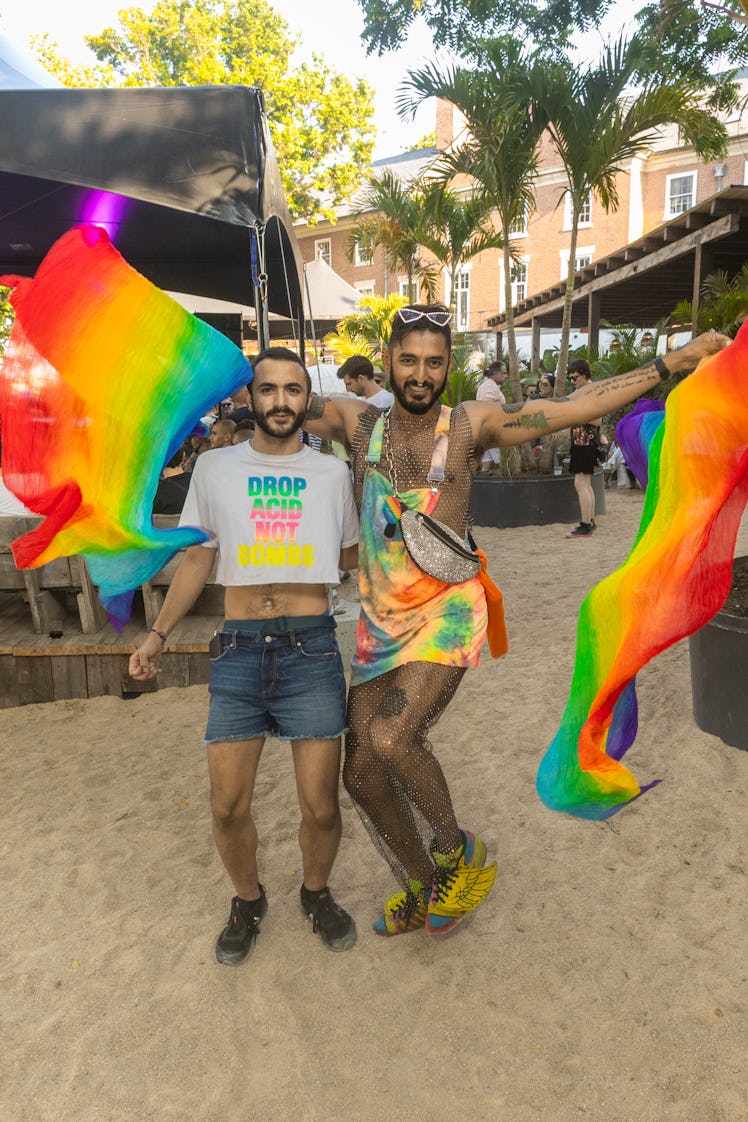 Two people wearing rainbows at a Pride celebration