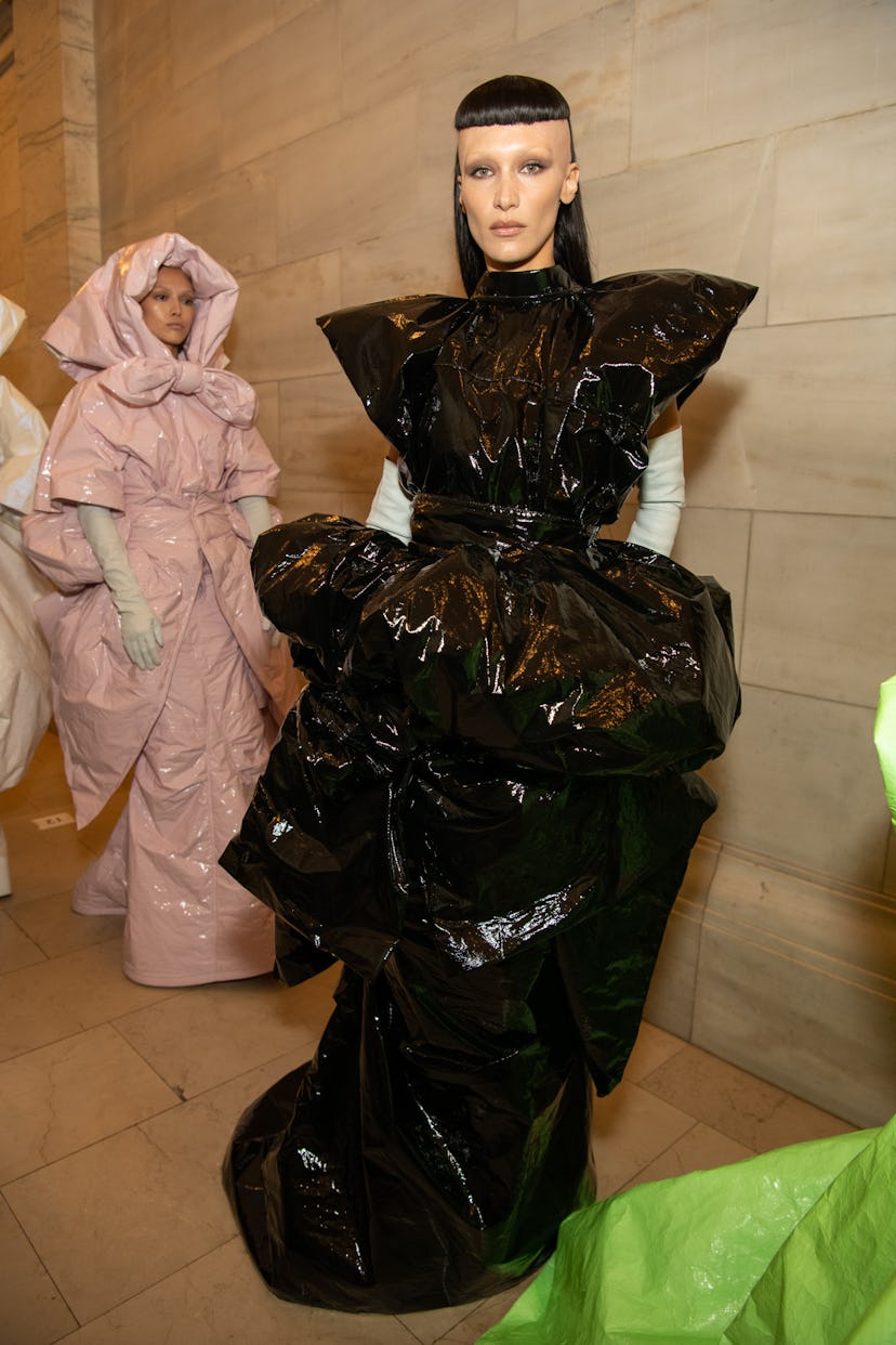 Bella Hadid wearing a large shiny black Marc Jacobs dress