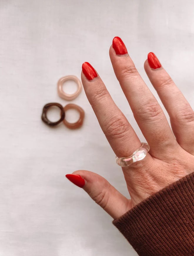 freckle and chain cloud ring on model's hand