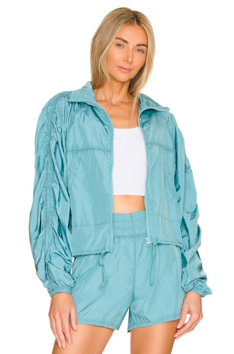 model wearing aquamarine parachute jacket from onzie for revolve