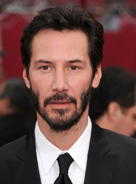 Full-profiled Keanu Reeves with his short patchy beard