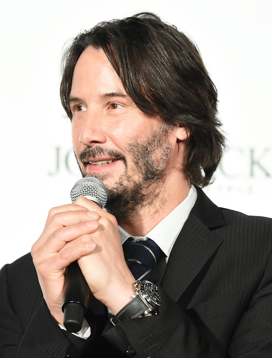 Full-profiled Keanu Reeves with his patchy beard