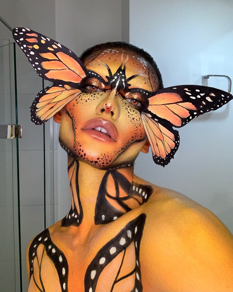 Beauty influencer, Indigo to Hell, poses in butterfly makeup