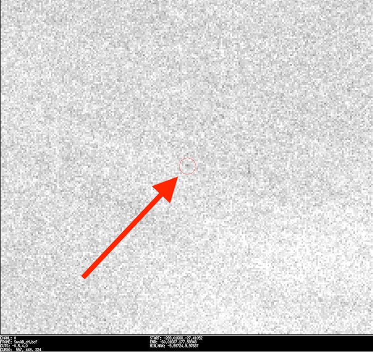 red arrow pointing to a small red circle, within which is a speck representing a meteorite