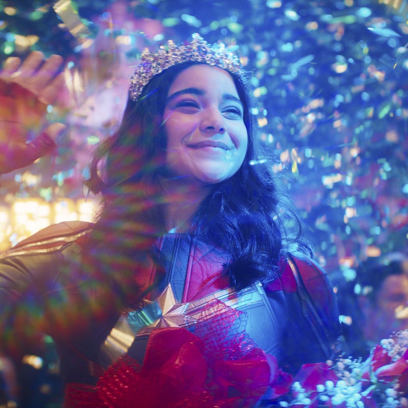 Ms. Marvel smiling and waving in her costume and a diamond tiara