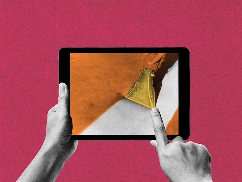 A person holding a tablet and pointing with a finger at the display with a vacuum on it