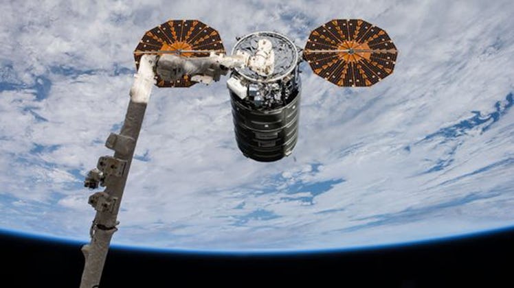 A previous Cygnus (OA-8) spacecraft is pictured after it had been grappled with the Canadarm2 roboti...