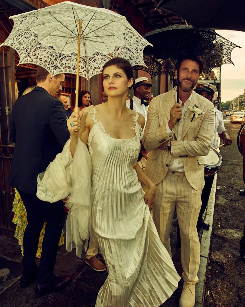 Alexandra Daddario carrying a parasol on her wedding day with Andrew Form