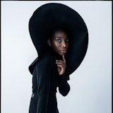 Michaela Coel wearing a large black hat