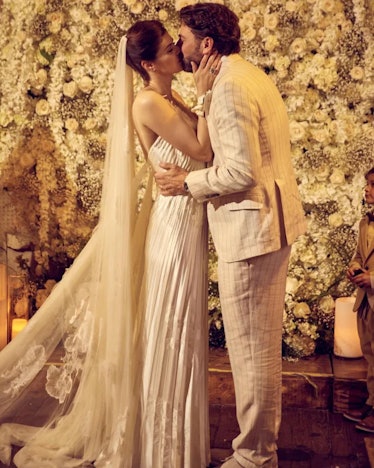 Alexandra Daddario and Andrew Form kissing on their wedding day