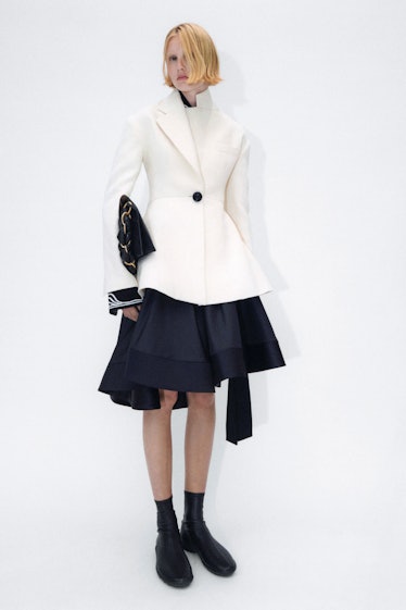 Model in a Proenza Schouler white jacket and black skirt
