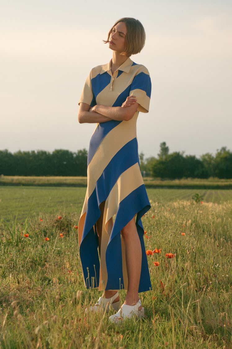 A female model posing in a blue and yellow Stella McCartney dress