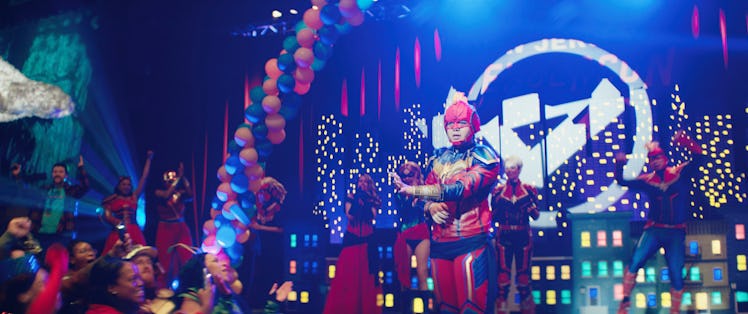 Kamala Khan (Iman Vellani) standing on-stage at AvengerCon in Ms. Marvel Episode 1