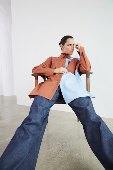 A female model sitting in a colorful Lafayette 148 shirt and pants