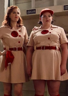A still from A League of Their Own where a group of girls is standing in uniforms