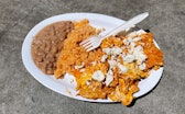 Plate of chilaquiles, rice, and beans.
