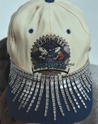 A necklace around a baseball cap