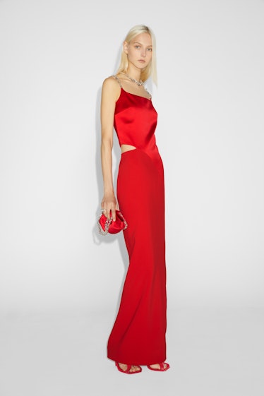 A blonde female model posing in a red Givenchy dress