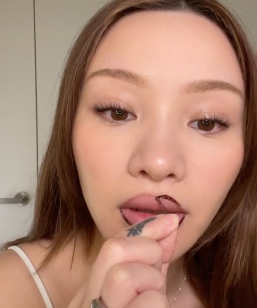 Influencer Sarah Cheung shows off a viral TikTok beauty hack using eyebrow tint as lipliner