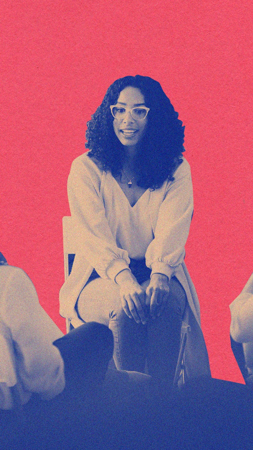 Five women sitting together and listening to a therapist speaking during group therapy