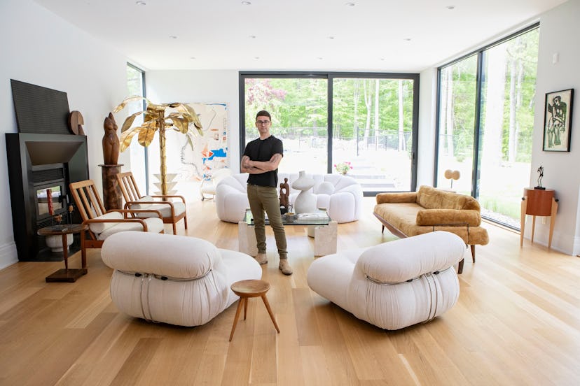 Christian Siriano posing in the living room of his Connecticut home