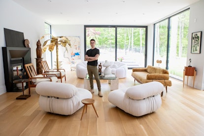Christian Siriano posing in the living room of his Connecticut home
