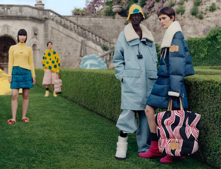 Models wearing colorful clothing in a sort of nice garden.