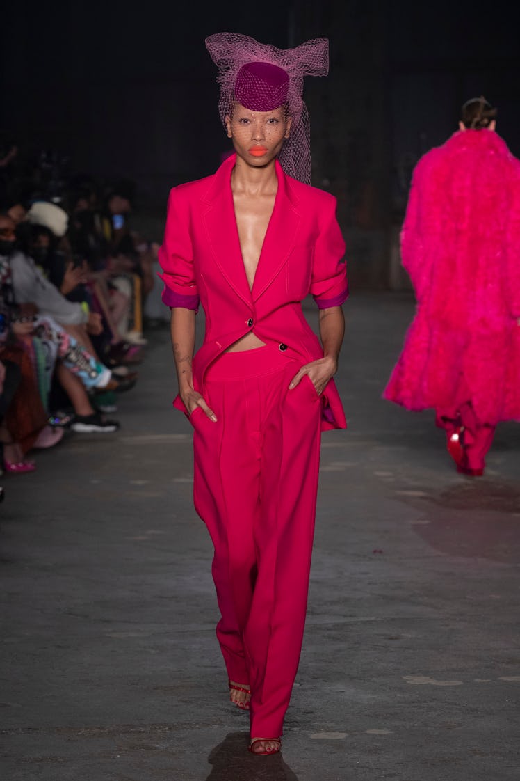 A model wearing a red blazer and pants at the Christopher John Rogers runway