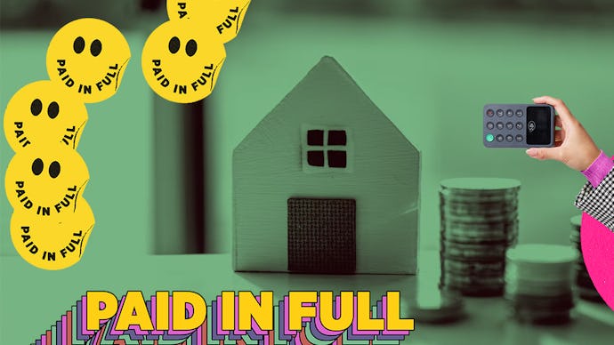 Cardboard house and some coins stacked beside it, with many of smiling faces with paid in full writi...