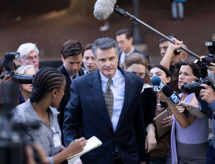 Colin Firth as Michael Peterson surrounded by reporters