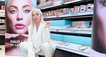 Lady Gaga in front of a Haus Labs display at a store