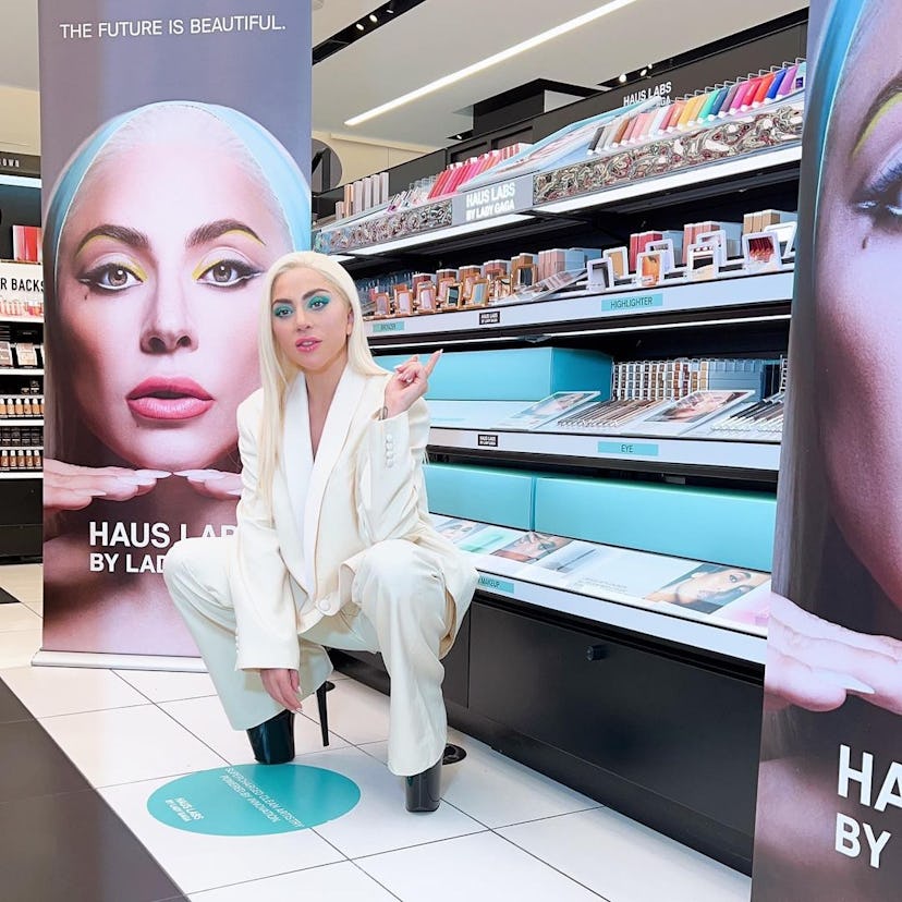Lady Gaga in front of a Haus Labs display at a store