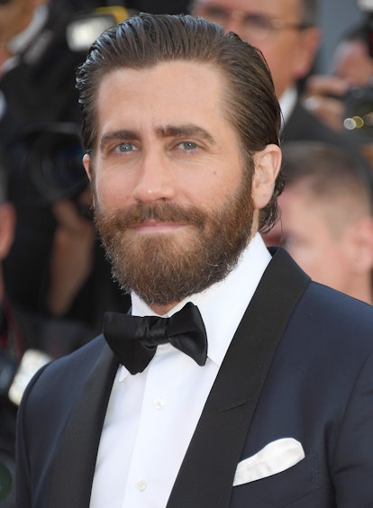 Jake Gyllenhaal with a medium-length beard in a formal suit