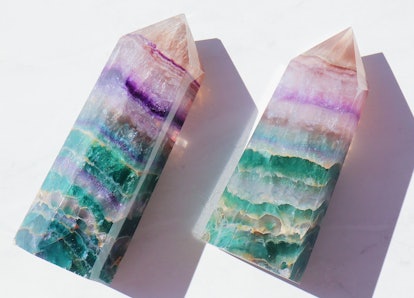 Two fluorite towers, crystals for empaths, on a white background