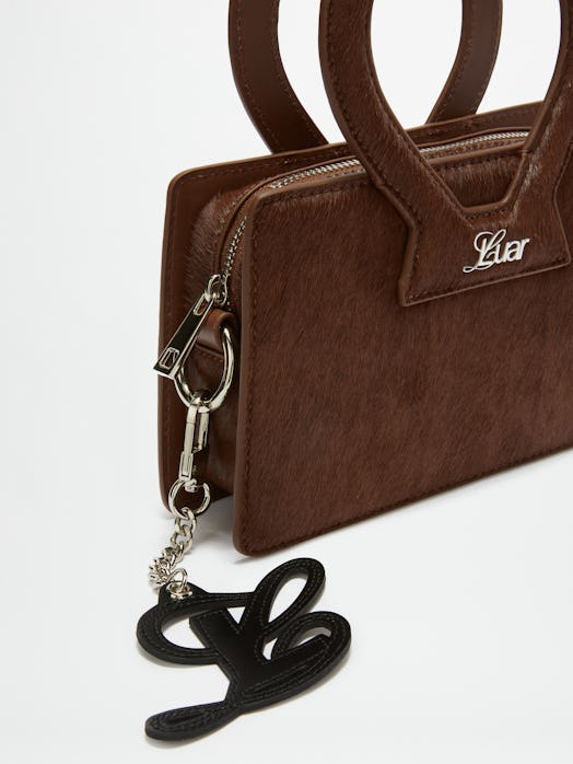 A brown LUAR x Opening Ceremony bag