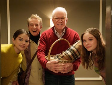 The cast of Only Murders in the building in an elevator all smiling at the camera