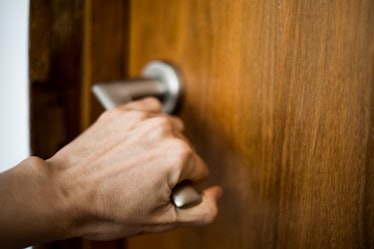 Close up on a hand closing a child's bedroom door.