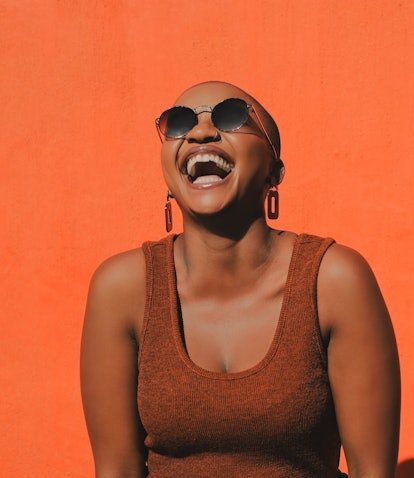 Young woman laughing over the full moon nicknames.