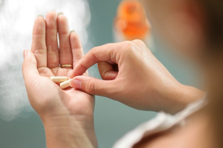 A woman holding abortion pills.