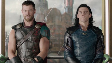 Chris Hemsworth's Thor and Tom Hiddleston's Loki stand next to each other in 2017’s Thor: Ragnarok