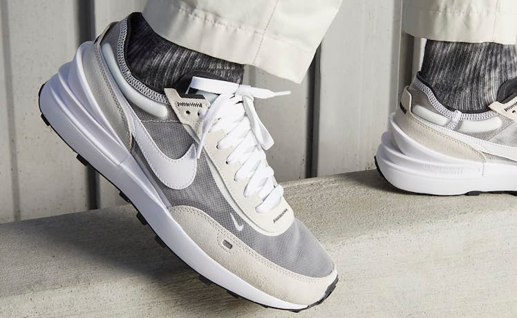 A person wearing Nike Waffle One sneakers