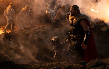 Chris Hemsworth's Thor stands on a battlefield in Thor: Love and Thunder