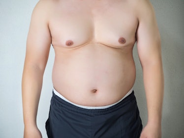 A shirtless man with man boobs.
