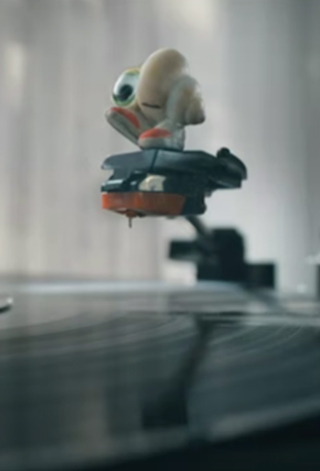 Marcel the Shell with Shoes On balanced on a record player needle.