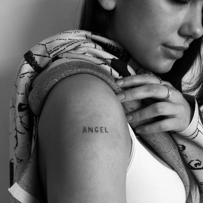 The word “angel” is tattooed on Dua Lipa’s right shoulder.