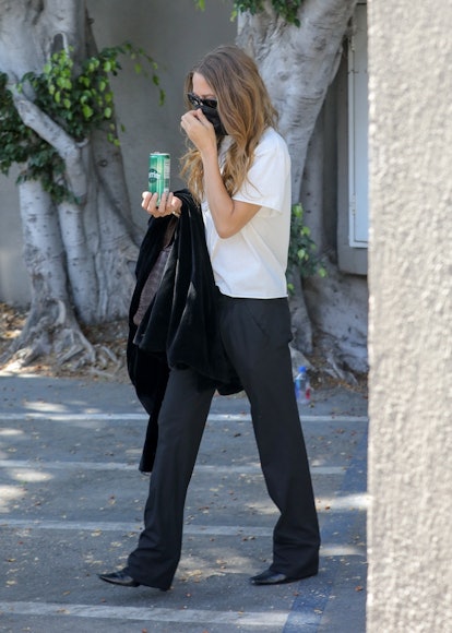 Mary-Kate Olsen is escorted to her car after some shopping on trendy Melrose Place in West Hollywood...