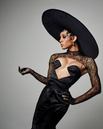 Michaela Jaé Rodriguez poses in a black Gucci dress and oversized hat on the set of her cover photo ...
