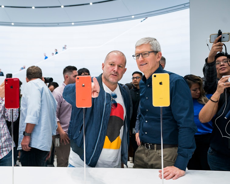 Jony Ive and Tim Cook look at iPhones